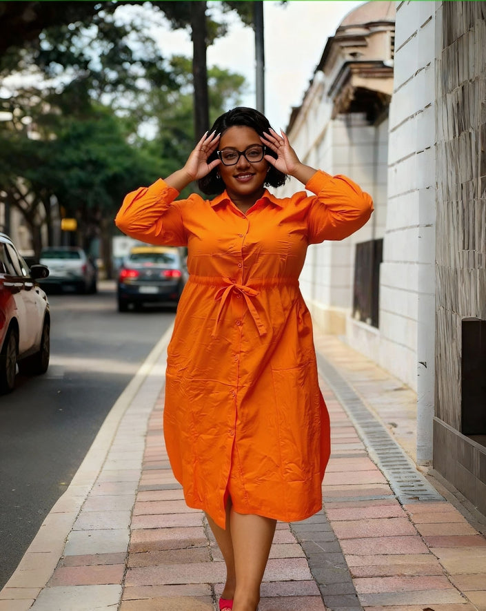 Orange plus-size button-down dress with long sleeves, front buttons, waist tie
