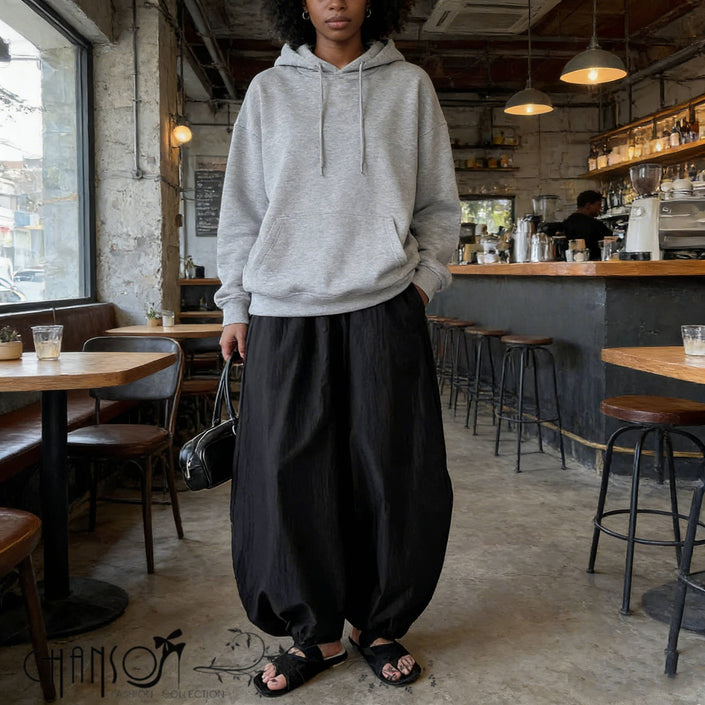 Relaxed fit harem pants in black, wide leg silhouette with gathered drop-crotch.