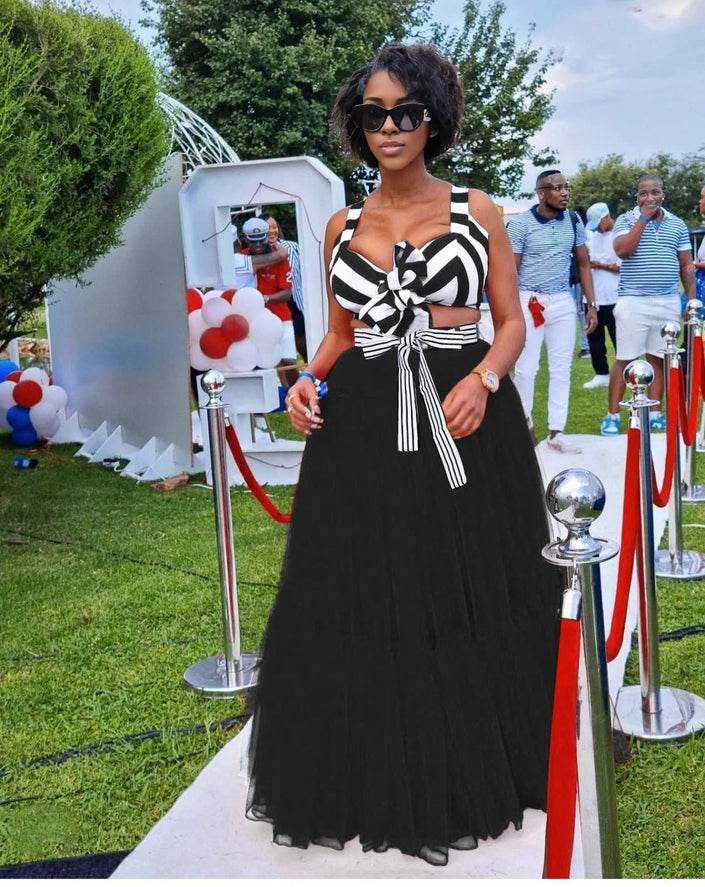 Black maxi skirt outfit with striped bow V-neck top and matching full-length skirt