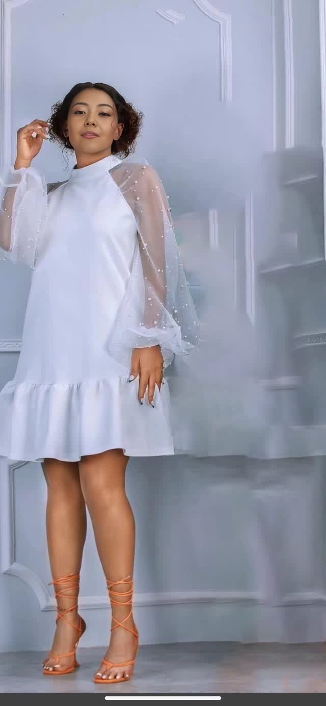 White mini dress with sheer puff sleeves and ruffle hem, flared skirt