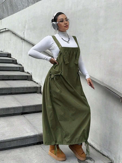 Olive maxi workwear dress with adjustable straps, front pockets, and gathered skirt