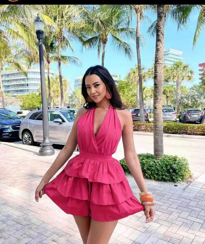 Layered halter jumpsuit, rose-red with deep V neckline and flared ruffle tiers