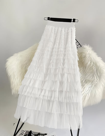 White pleated layered midi skirt with ruffled tiers and tulle-like texture