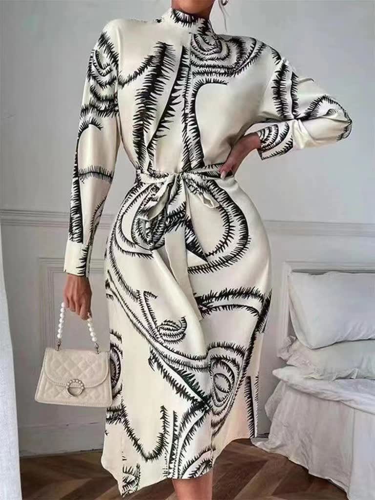 Off-white printed midi dress with high neck, long sleeves, and tie waist belt.