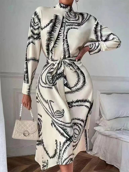Off-white printed midi dress with high neck, long sleeves, and tie waist belt.