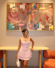 Light pink sleeveless pleated mini dress with tiered ruffle skirt and scoop neckline