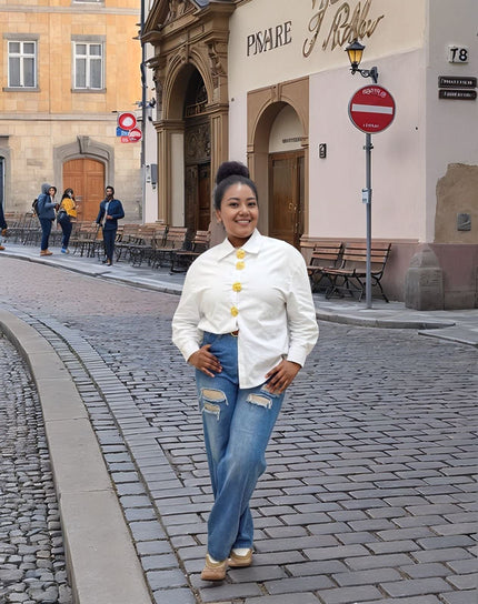 White vintage style button-up shirt with gold-tone buttons and stand collar