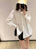 White long-sleeve pleated blouse close-up with pintuck front and button cuff