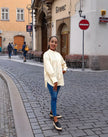 White long-sleeve pleated blouse with pintuck detailing and button placket