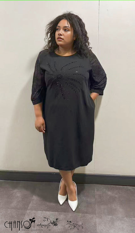 Black midi dress with 3/4 sleeves and beaded floral embellishment on front