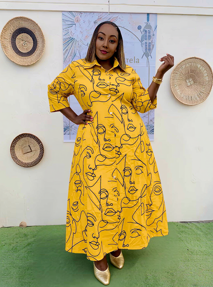 Yellow plus-size shirt dress with abstract face line print, short sleeves, button front.