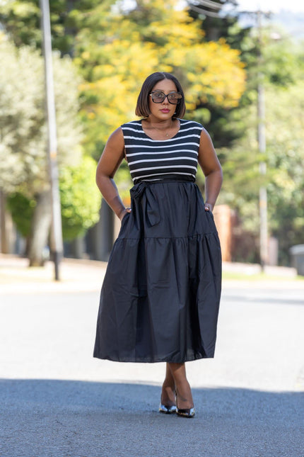 Navy sleeveless midi dress with white horizontal stripes and dark gathered waist skirt