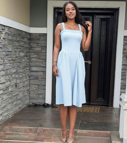 Light-blue pleated maxi dress with square neckline and gathered straps, full skirt