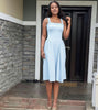 Light-blue pleated maxi dress with square neckline and gathered straps, full skirt