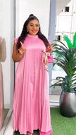 Light-pink pleated maxi dress with high neck and long flowing skirt