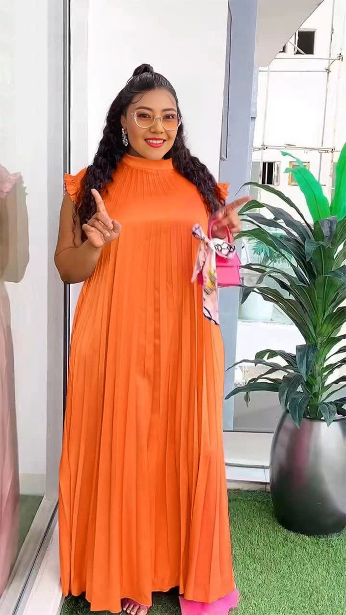 Orange-red pleated maxi dress with high neck and long flowing skirt