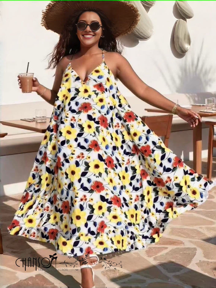 Floral maxi dress with spaghetti straps, V-neck, and flowing tiered skirt in yellow, red, and white.