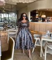 Geometric midi dress with waist tie, long sleeves, off-shoulder square neckline