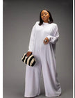 White relaxed-fit jumpsuit with long sleeves, high neckline, wide legs, side pockets