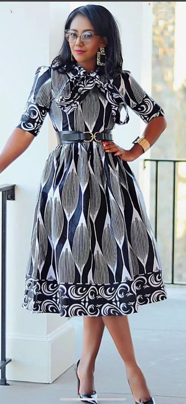 Black and white patterned midi dress with 3/4 sleeves, flared skirt, waist belt