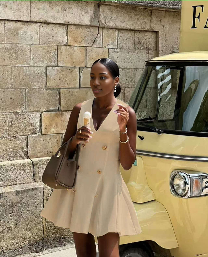 Cream sleeveless blazer mini dress with gold button front and V-neck