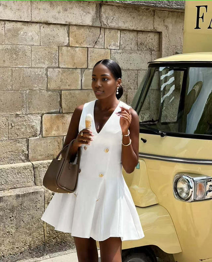White sleeveless blazer mini dress with gold button front and V-neck