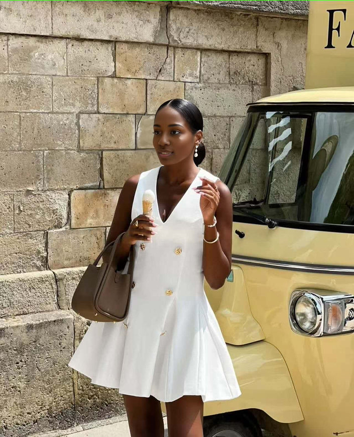 White sleeveless blazer mini dress with gold button front and V-neck