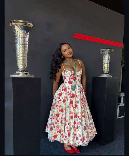 Vintage A-line floral midi dress, white with red flowers, halter straps and fitted bodice.