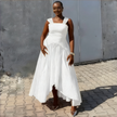 High-low pleated dress in white with square neckline and draped asymmetrical skirt