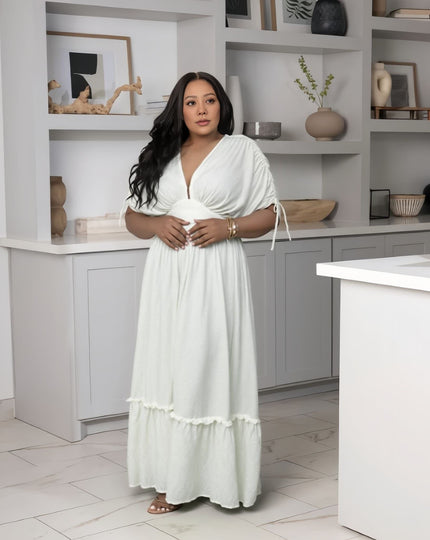 White maxi dress with gathered waist and ruffled hem, drawstring sleeves, V-neck