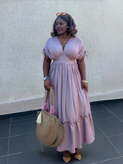 Light pink maxi dress with gathered waist and ruffled hem, V-neck, short tie sleeves