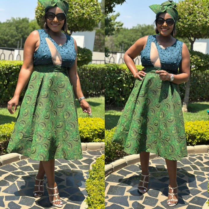 Sleeveless A-line midi dress with blue patterned bodice and green swirl skirt, V-neck