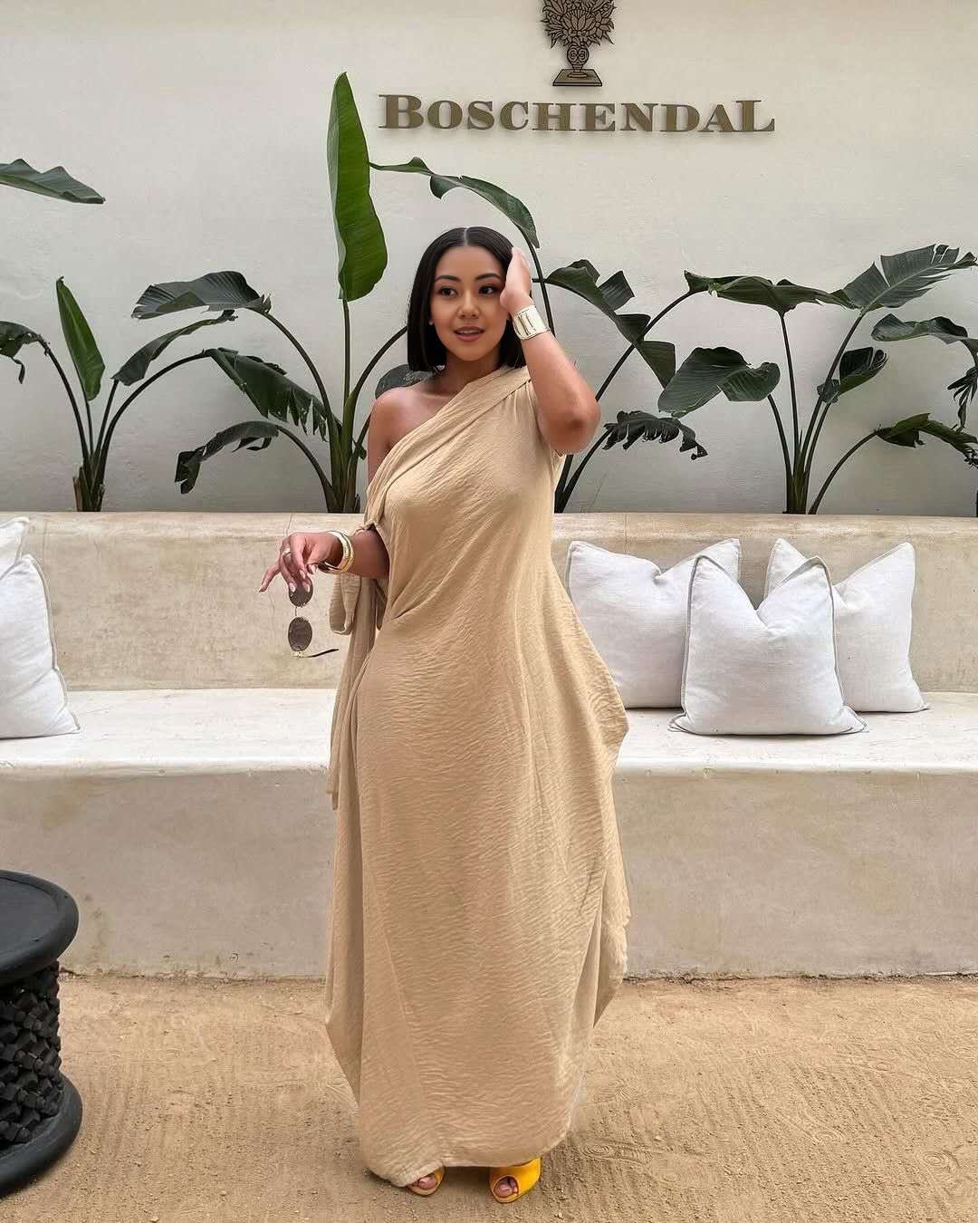 Nude one-shoulder maxi dress with layered loose fit and asymmetrical drape