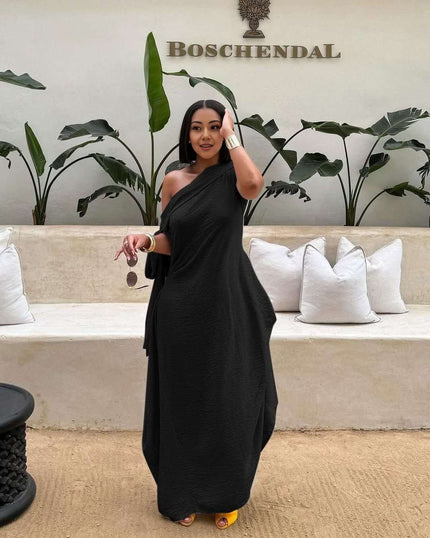 Black one-shoulder maxi dress with layered loose fit and draped crossover neckline