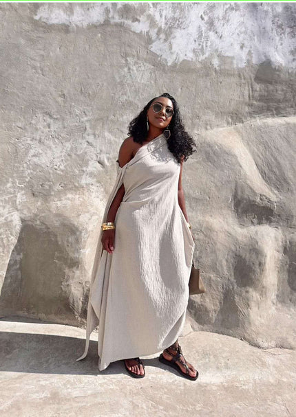 Beige one-shoulder maxi dress with draped drapery and flowy layered silhouette
