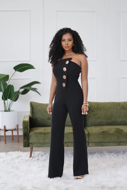 Black one-shoulder jumpsuit with fitted waist, oval button placket and wide legs