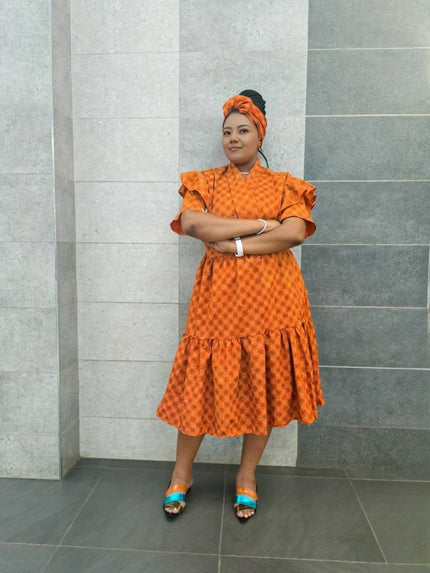 Orange midi dress with ruffled sleeves, textured pattern and tiered skirt