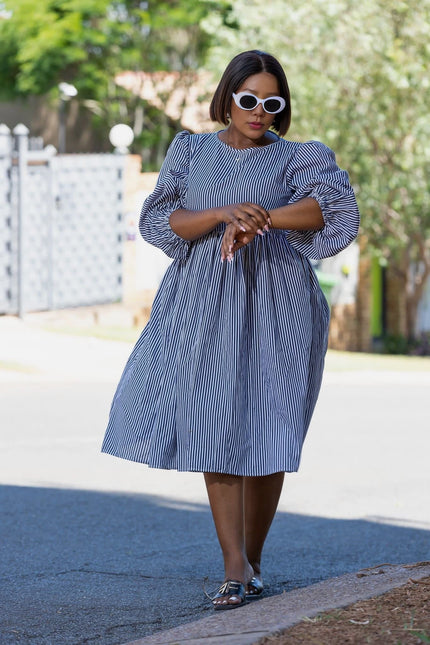 Blue-and-white striped puff-sleeve dress with gathered waist, knee length