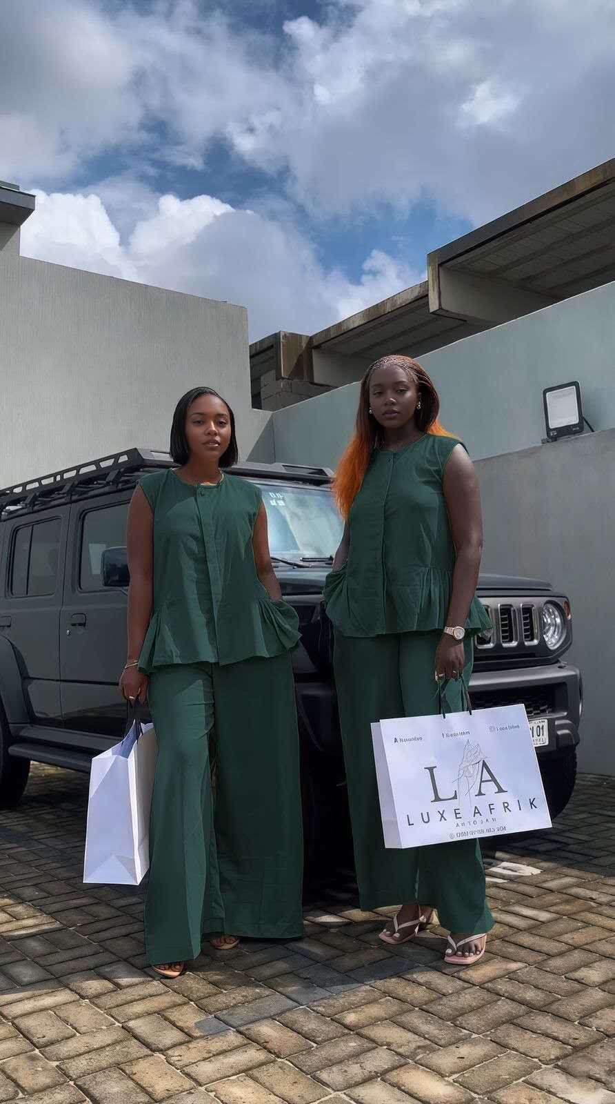 Dark-green sleeveless peplum top with matching wide-leg pants twin set outfit