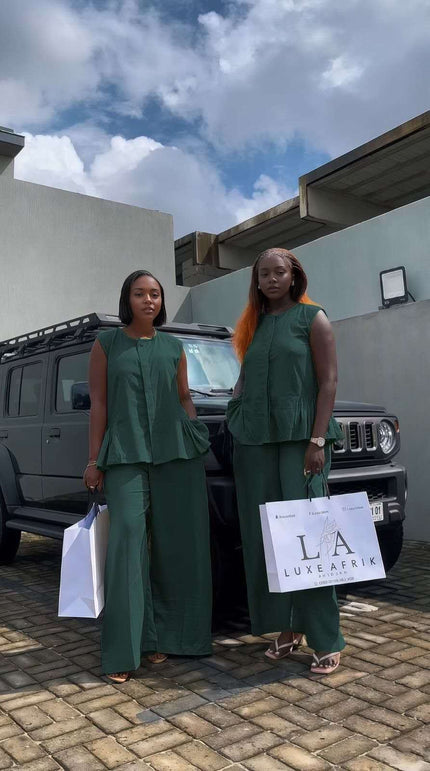Dark-green sleeveless peplum top with matching wide-leg pants twin set outfit