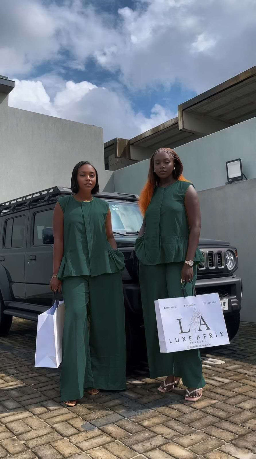 Dark-green sleeveless peplum top with matching wide-leg pants twin set outfit