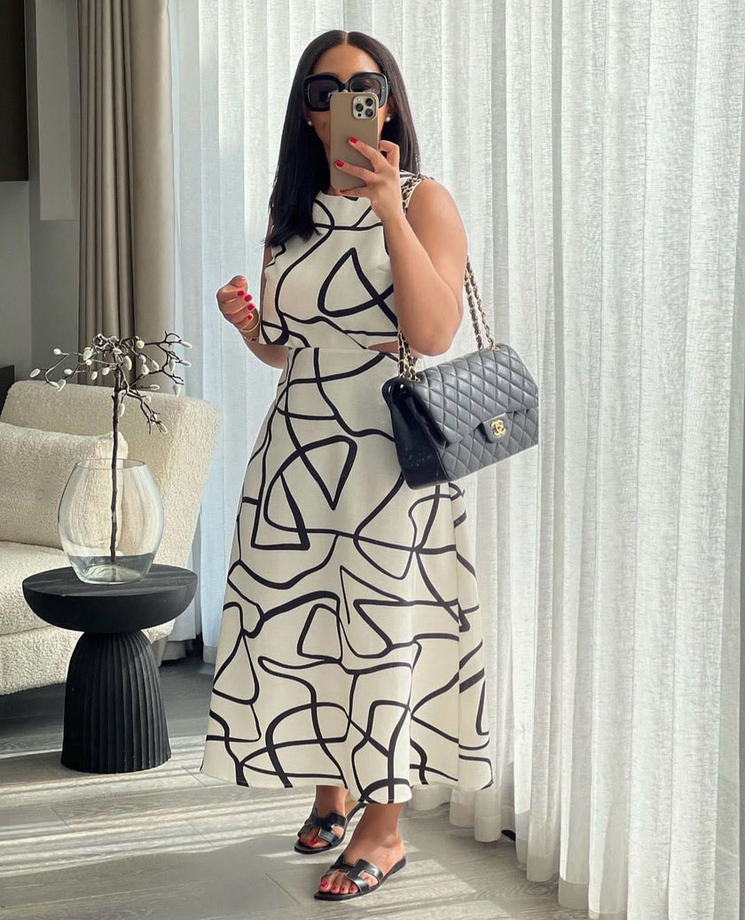 White and black abstract print sleeveless A-line midi dress with round neckline