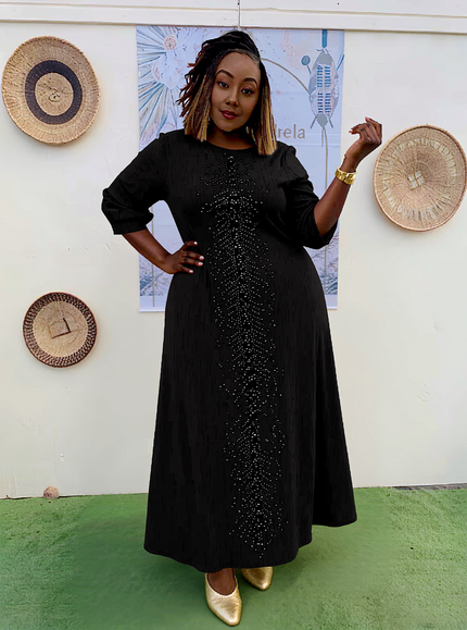 Plus size evening dress in black with sparkly sequin front and long puff sleeves