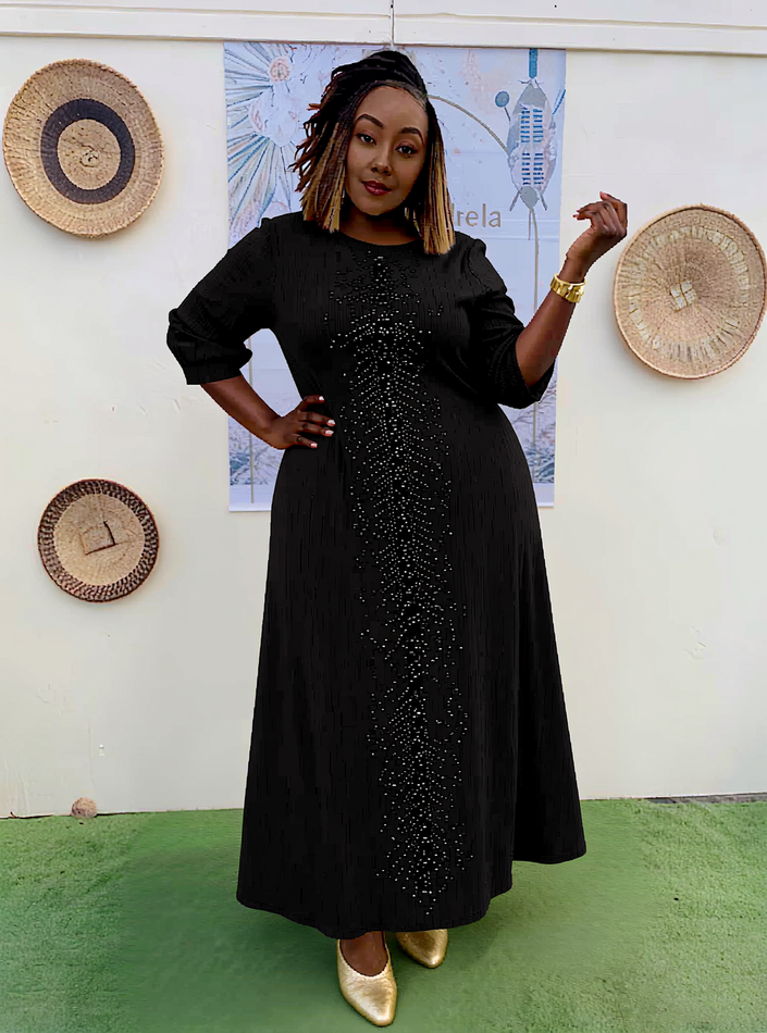 Plus size evening dress in black with sparkly sequin front and long puff sleeves
