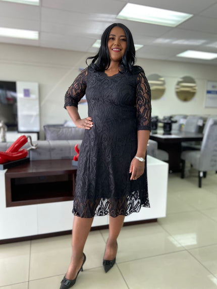Black lace midi dress with 3/4 sleeves and floral overlay, fitted waist