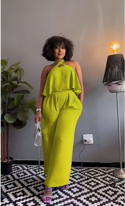 Lime green sleeveless cross-neck jumpsuit with cascading ruffle top and wide legs