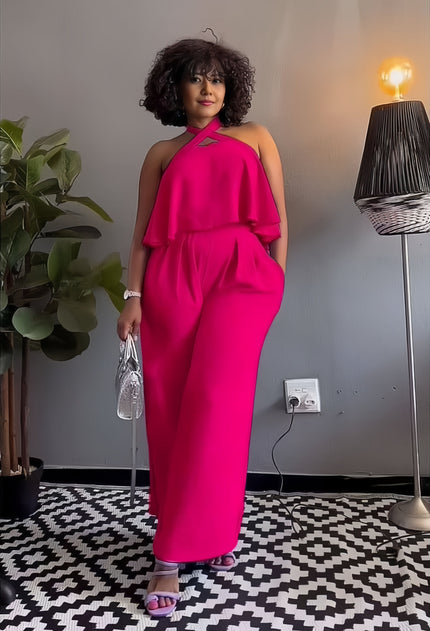 Hot pink sleeveless cross-neck jumpsuit with draped ruffle neckline and wide legs