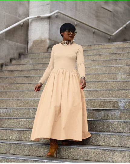 Nude maxi dress with long sleeves, high neckline, and gathered A-line skirt