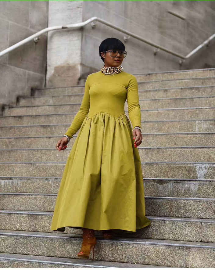 Yellow maxi dress with long sleeves, high neckline, and gathered A-line skirt