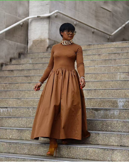 Brown maxi dress with long sleeves, high neckline, and gathered A-line skirt
